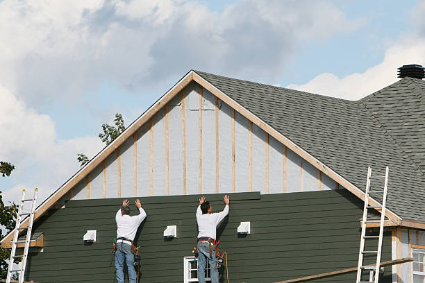 Professional Siding technician working in Island Park, NY